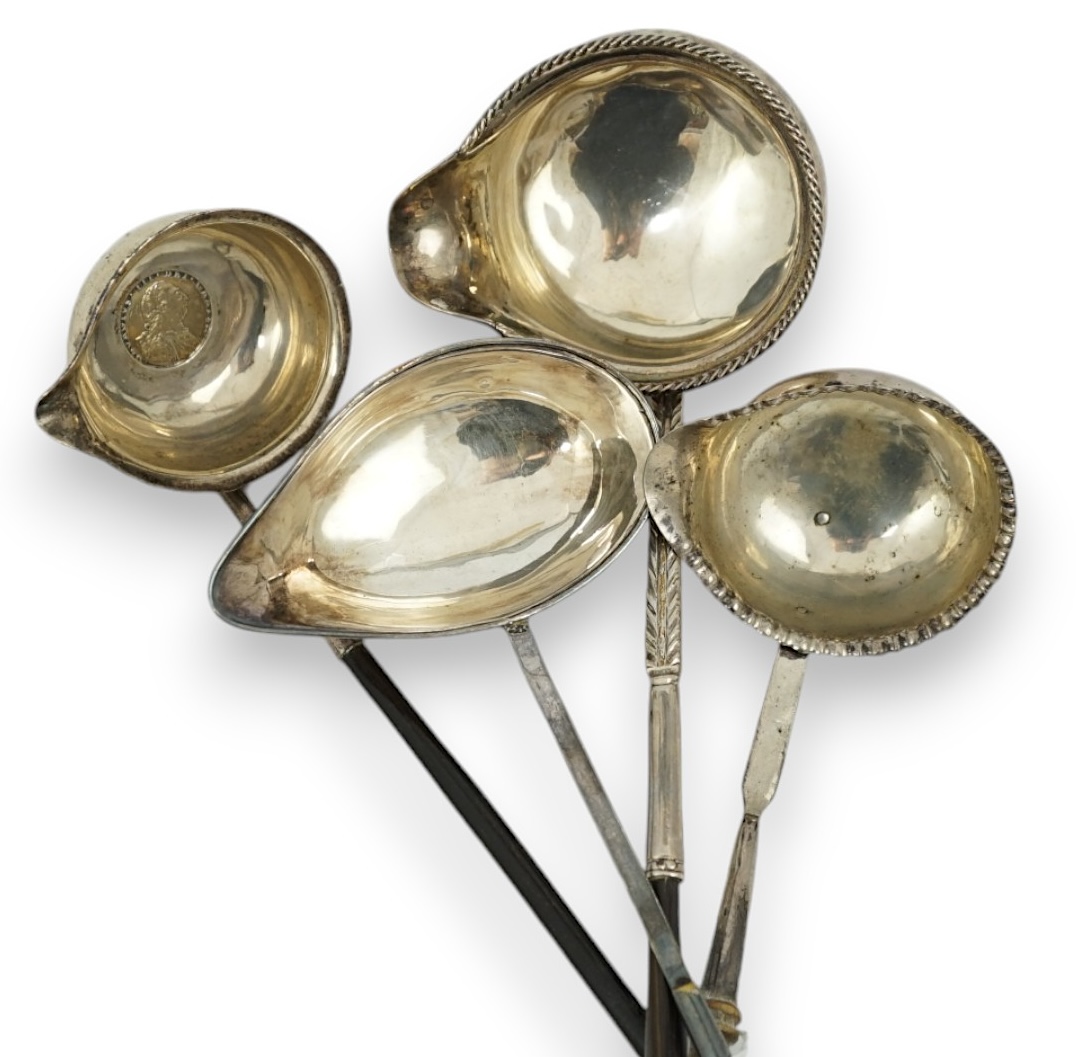 A Georgian silver toddy ladle, makers mark stamped four times (rubbed), 43cm and three other unmarked toddy ladles.